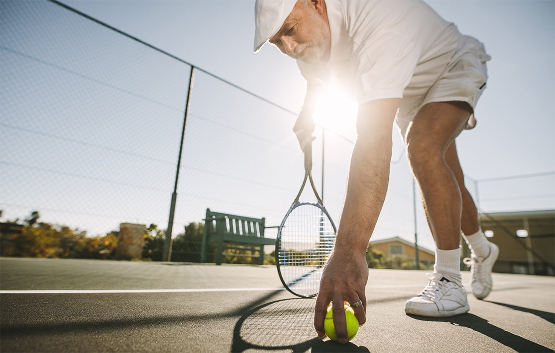 Senior man playing tennis