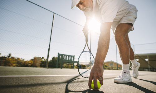 Senior man playing tennis