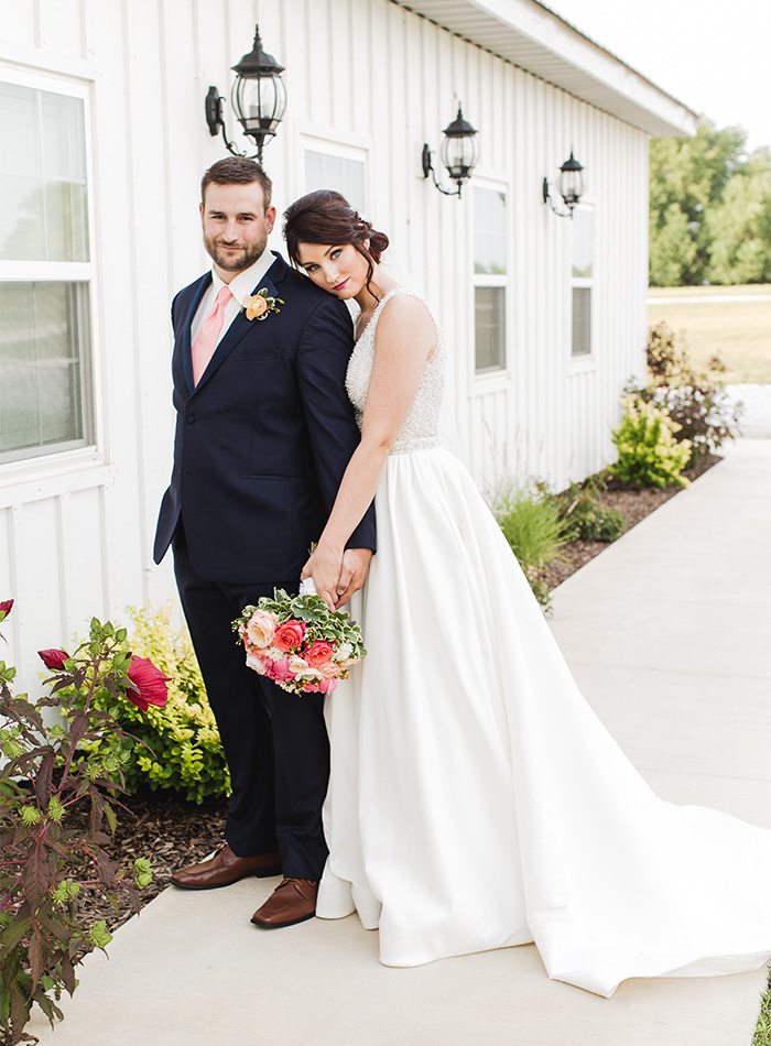 bride and groom with a pink bouquet