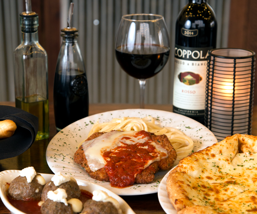 Italian food and wine including meatballs, chicken Parmesan and pizza