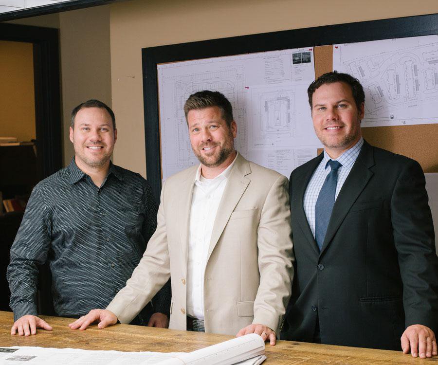 Dave, Sam M. and Dan Coryell, left to right, at the TLC Properties office.