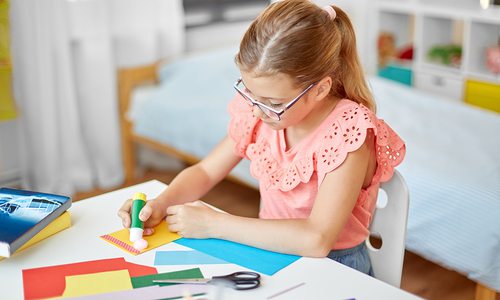 Young girl creating artwork at home