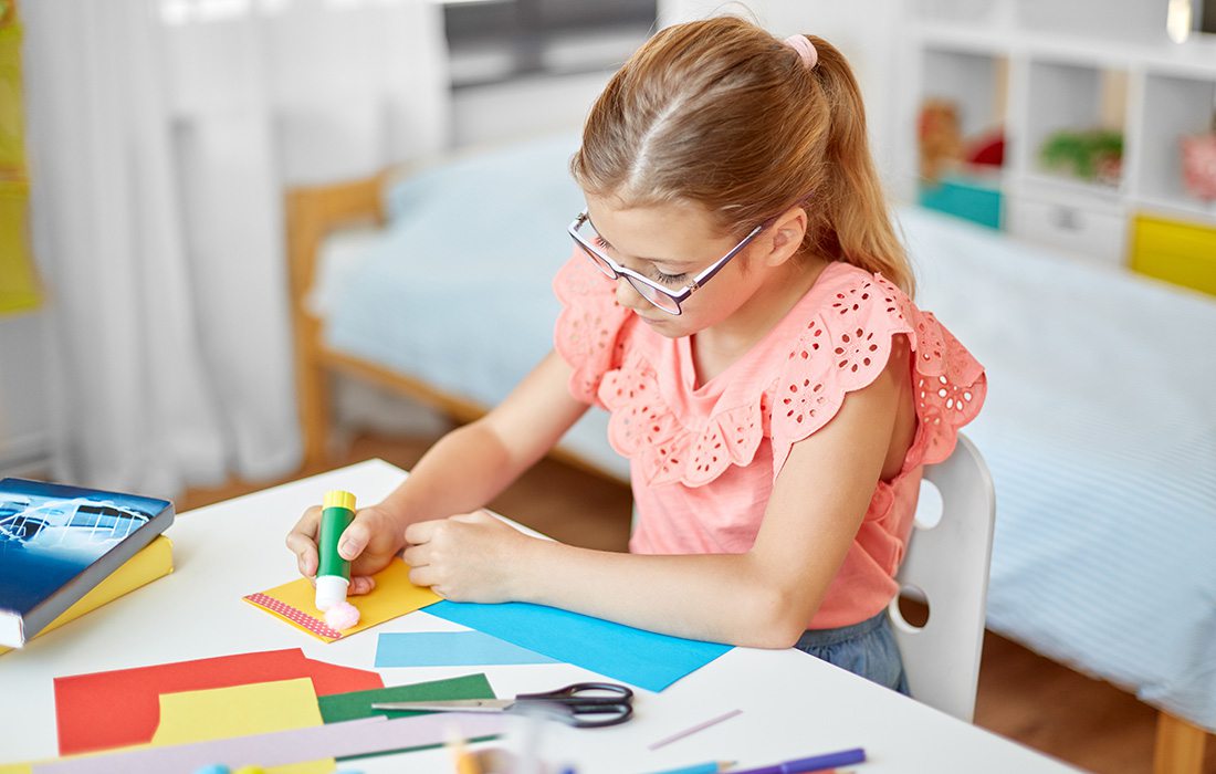 Young girl creating artwork at home