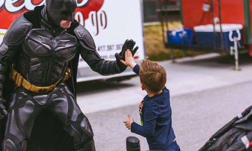 Springfield MO Batman high fiving a kid