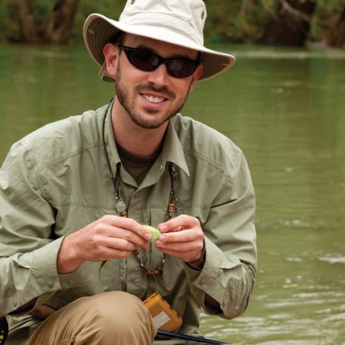 guy on river fishing