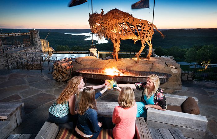 women cheersing drinks over looking the lake