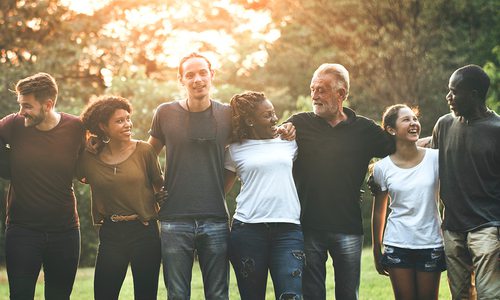 Diverse group of people arm in arm