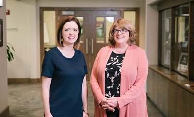 Winter Kinne and Louise Knauer in hallway at CFO