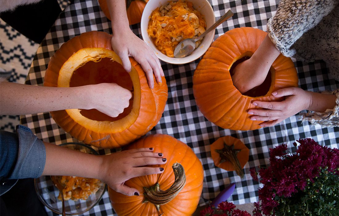 people carving pumpkins