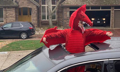 young child dressed as a red dragon