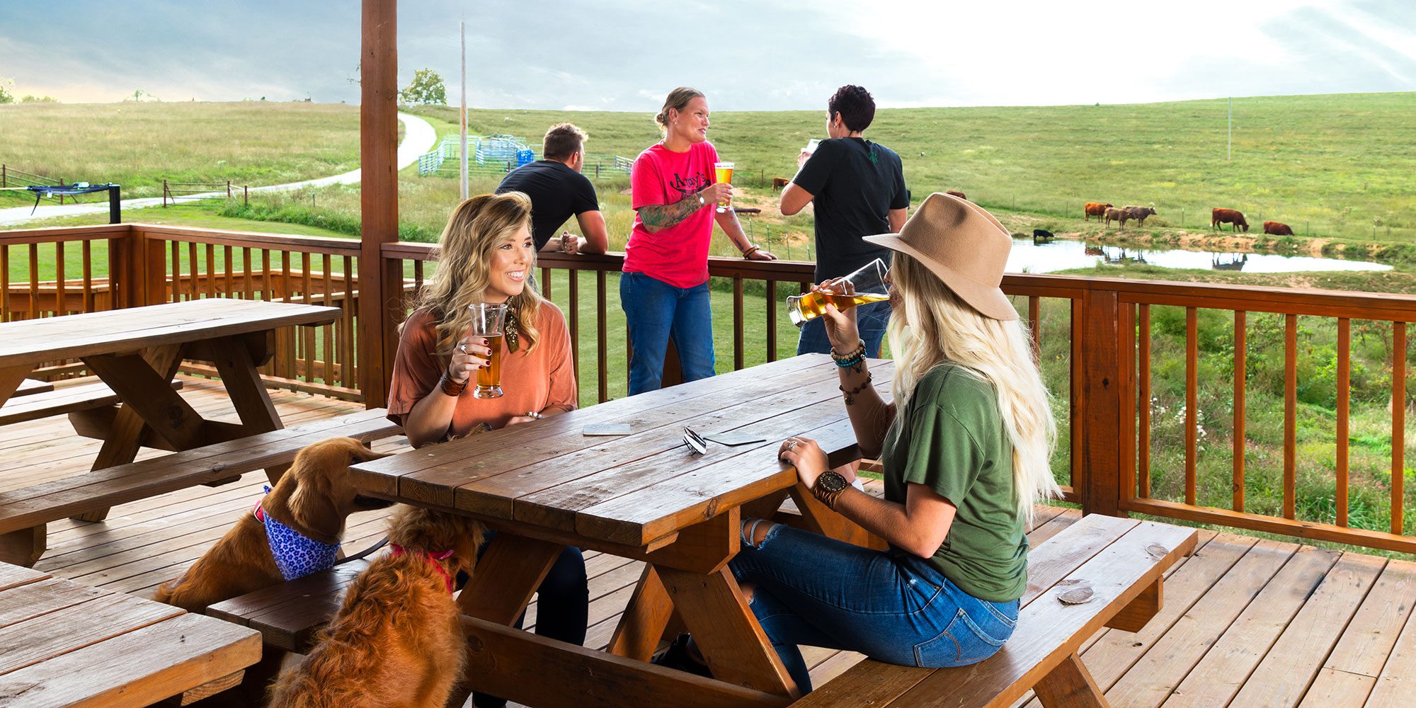 people sitting at a picnic table on a deck at Piney River Brewery in southwest Missouri