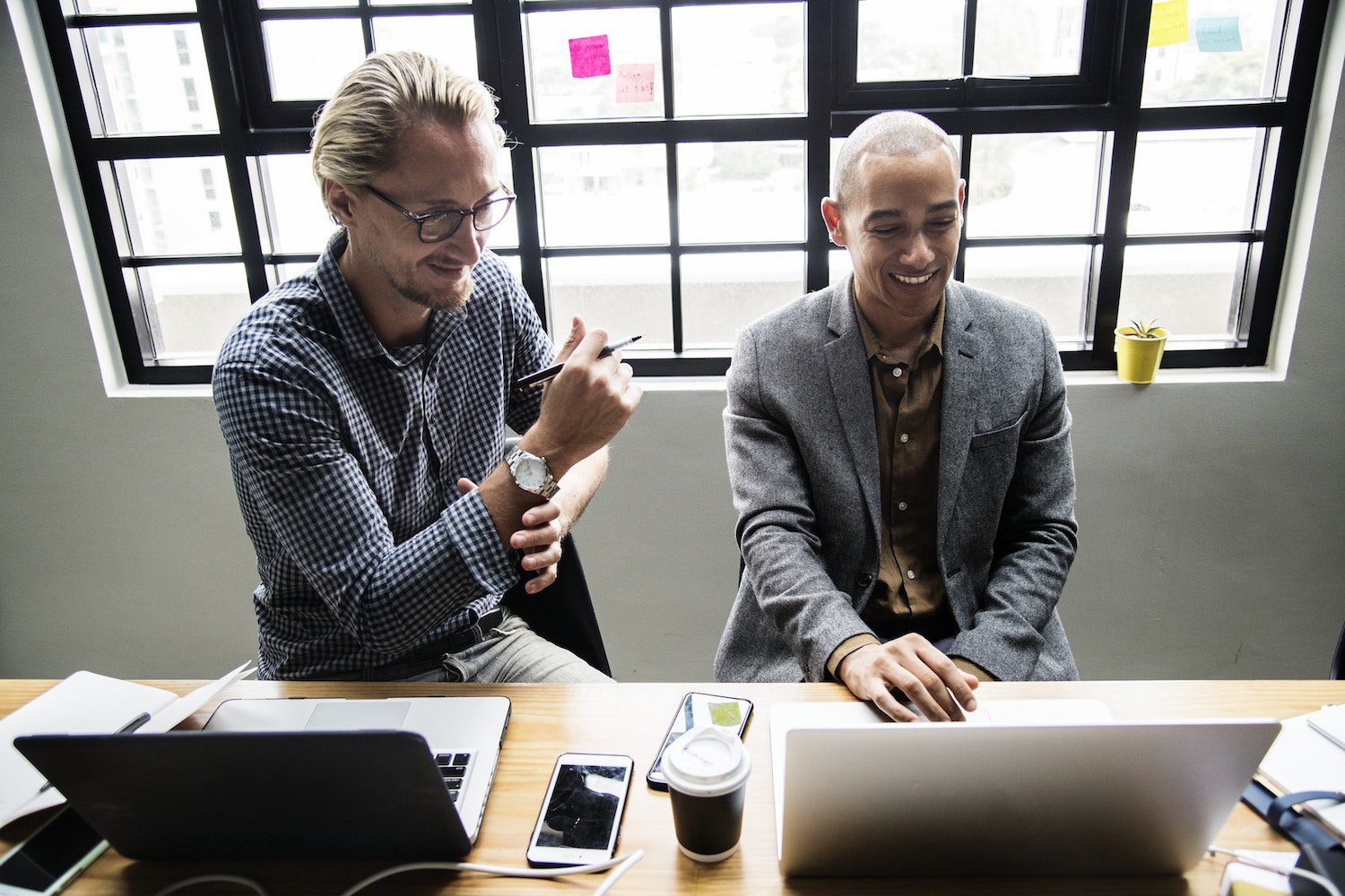 two people working on laptop computers