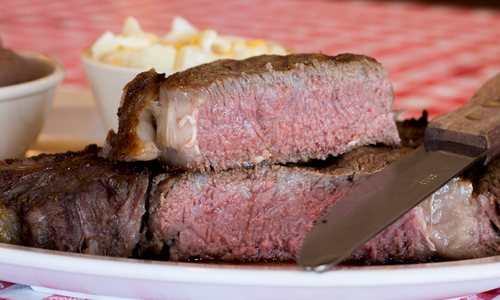 Dine on Giant Steaks at Doe’s Eat Place