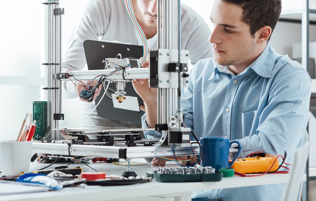 two engineering students with a 3D printer