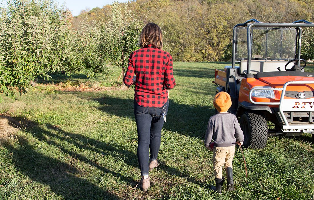 mother and son at apple orchard