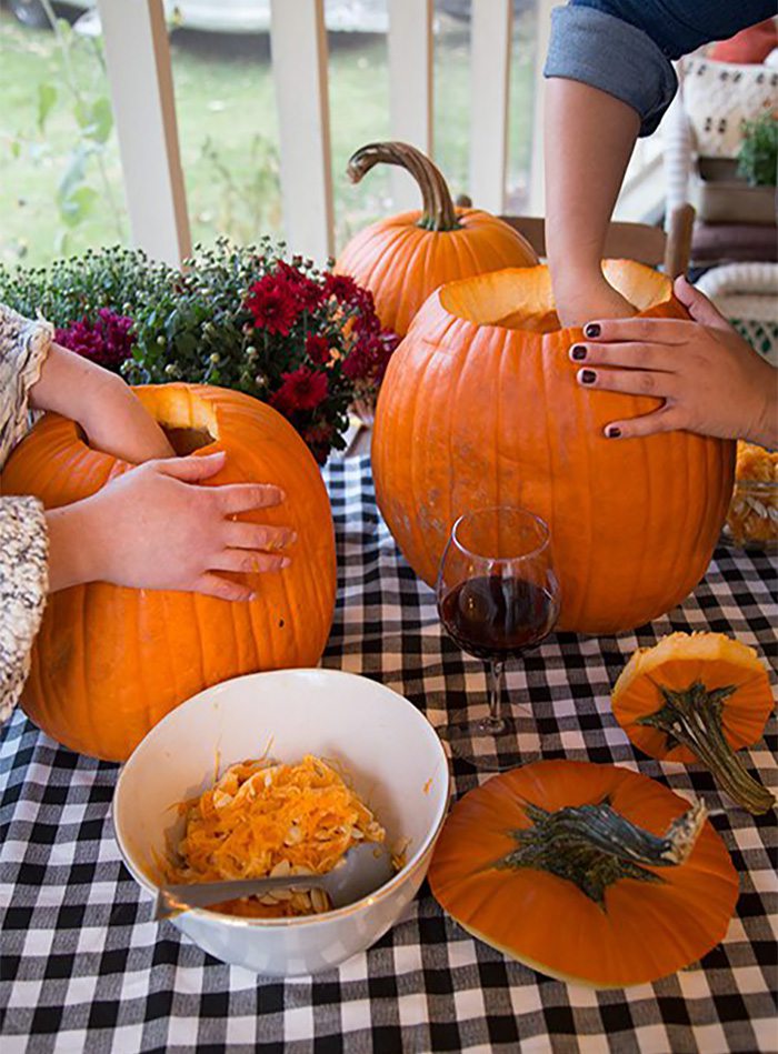 people carving pumpkins