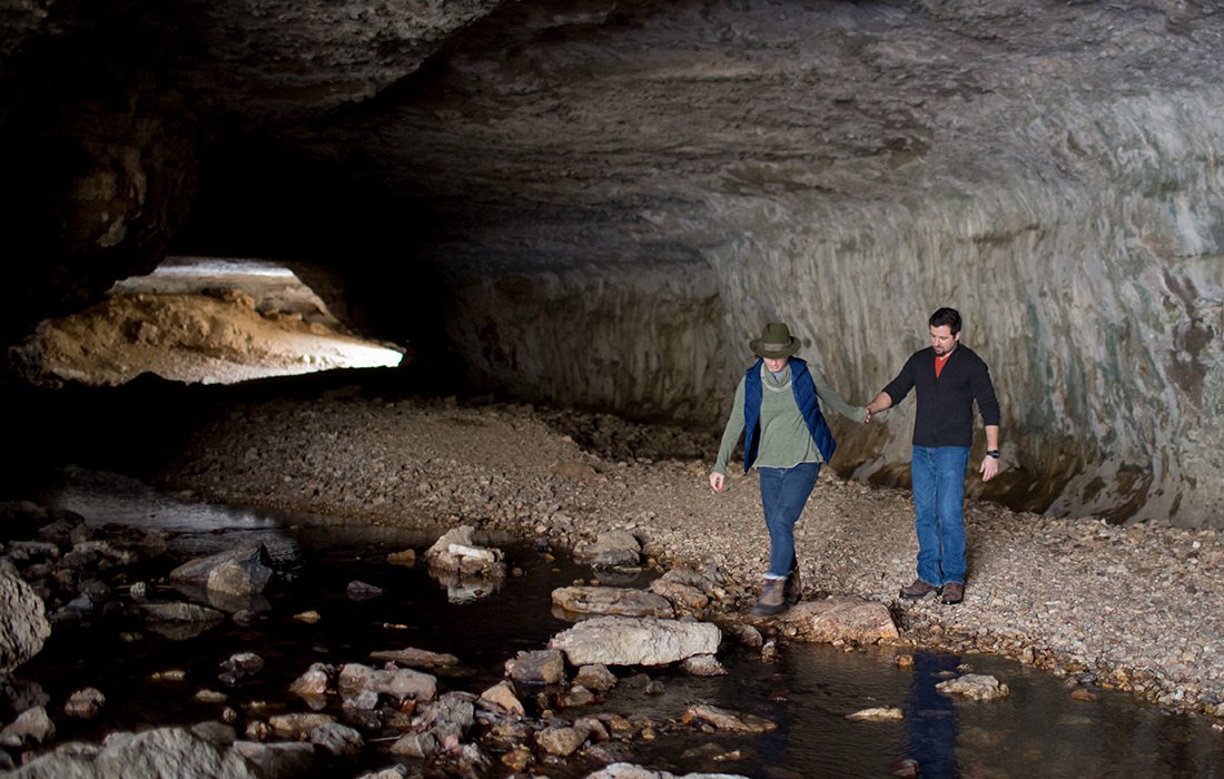 Young couple walking through the Natural Tunnel along Natural Tunnel Trail