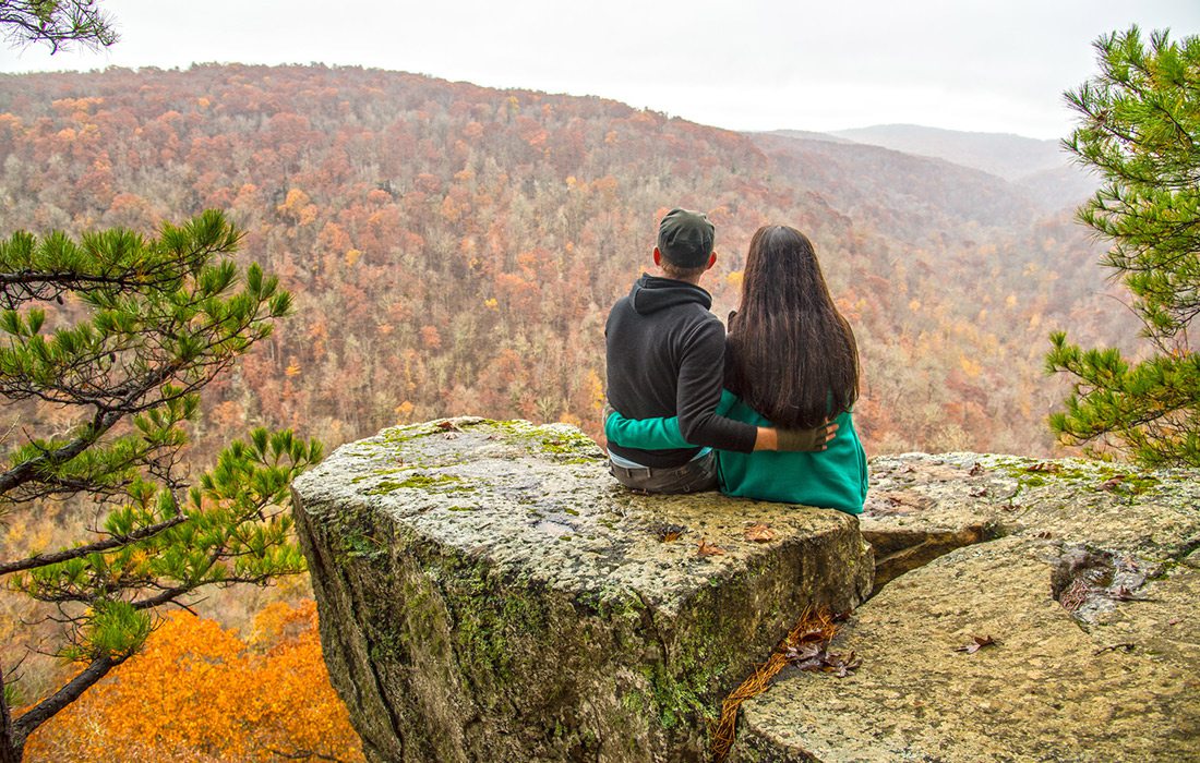 Couple taking in the scenic views along Hawksbill Crag trail in Arkansas