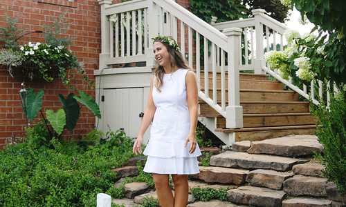 Katelyn Reynolds in white dress on steps