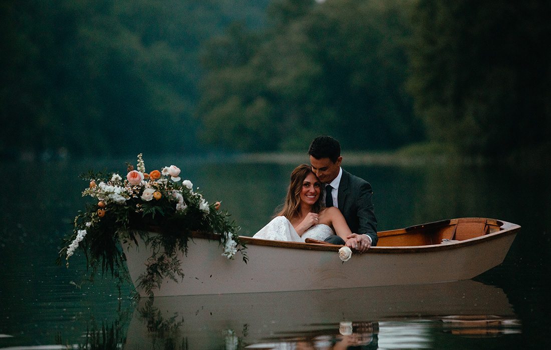 A bride and groom out on boats at Finely Farms.