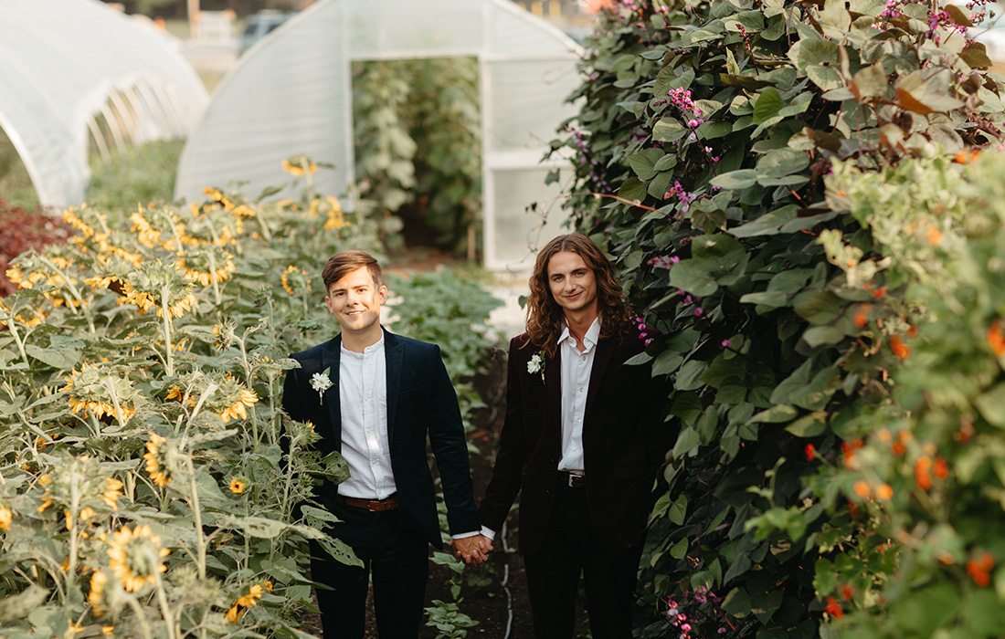 A newleywed couple among the flowers at Finley Farms.