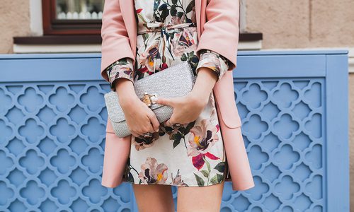 Woman in a floral dress and pink coat