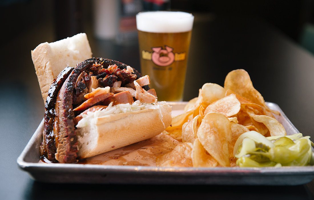 BBQ sandwich with chips and a beer at Gettin' Basted in Branson MO