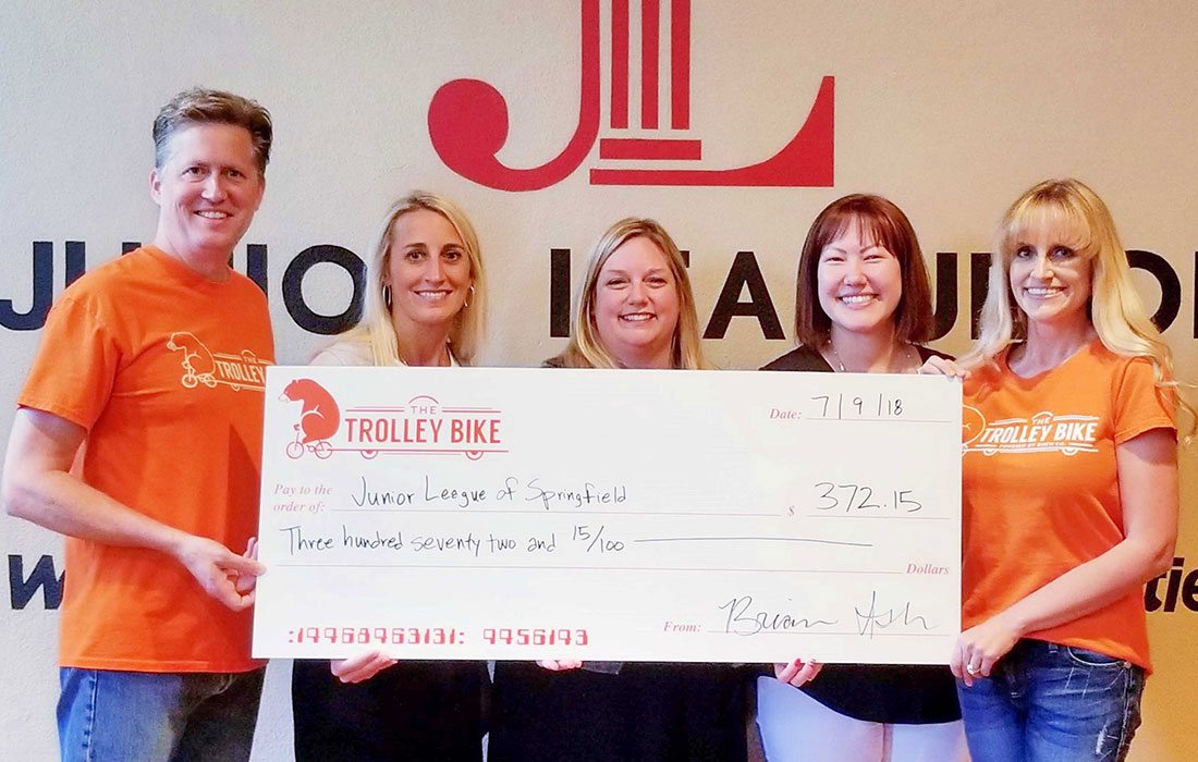 Brian Ash and Cortney Little-Ash (far right) present a check to Junior League of Springfield, MO