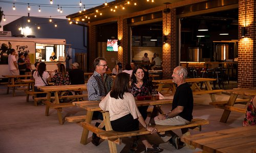 Groups of people drinking beers on the patio at Hold Fast Brewing in Springfield MO