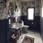 Slider Thumbnail: Copper sink in navy and floral bathroom with wallpaper by Adrian Rhoads.