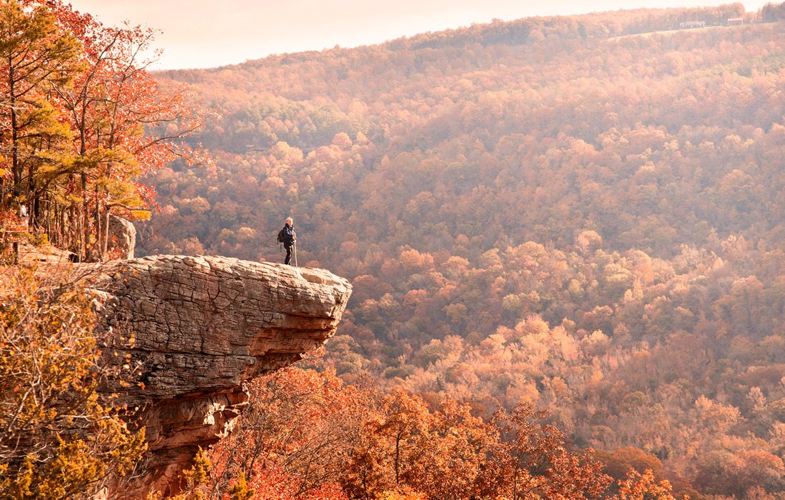 Hiker standing on cliff at Hawksbill Crag