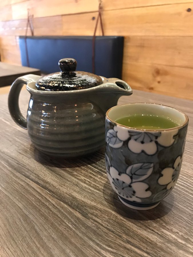 Green tea in pretty tea pot and glass