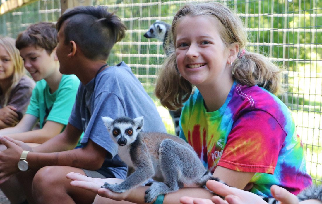 Young girl with a lemur at Cub Creek Science Camp in Rolla, Missouri