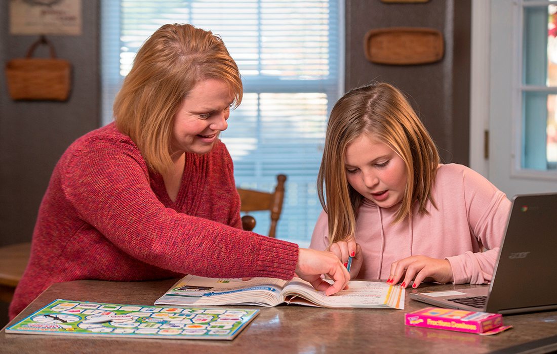 Woman tutoring a young girl