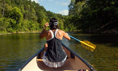 Woman paddling in a canoe on the Kings River