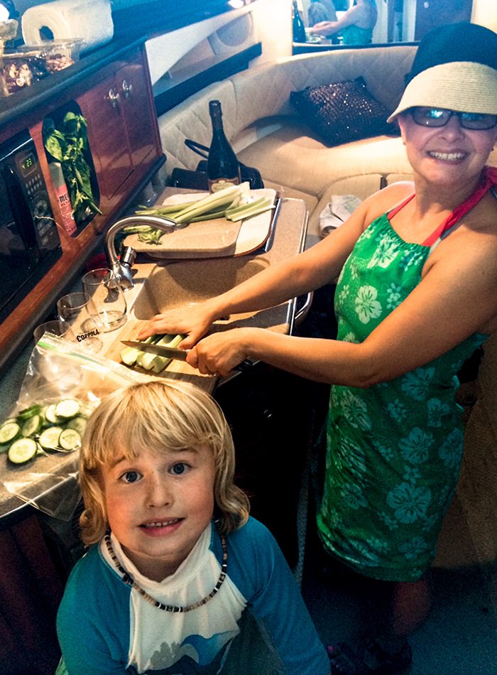 Elle Feldman and family cooking on their cabin cruiser boat