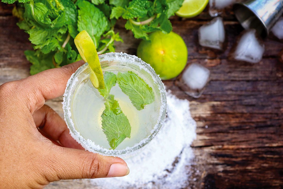 A hand holding a margarita.