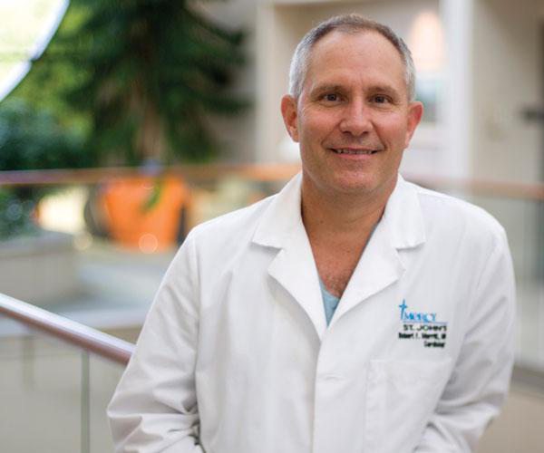 Doctor in white coat inside hospital lobby