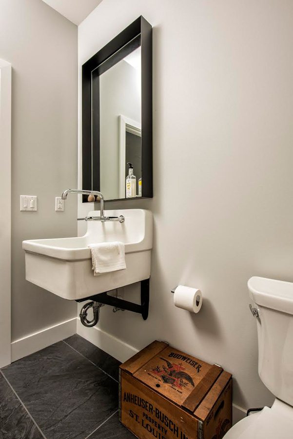 Minimalist bathroom with farmhouse sink by Jason Bekebrede.