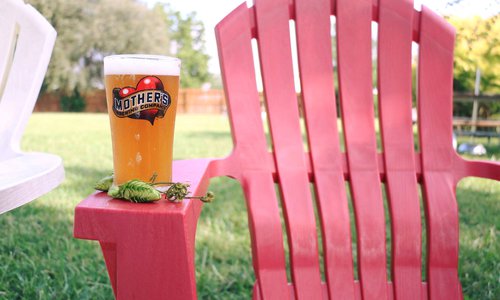 mother's brewing company beer on a lawn chair in the backyard