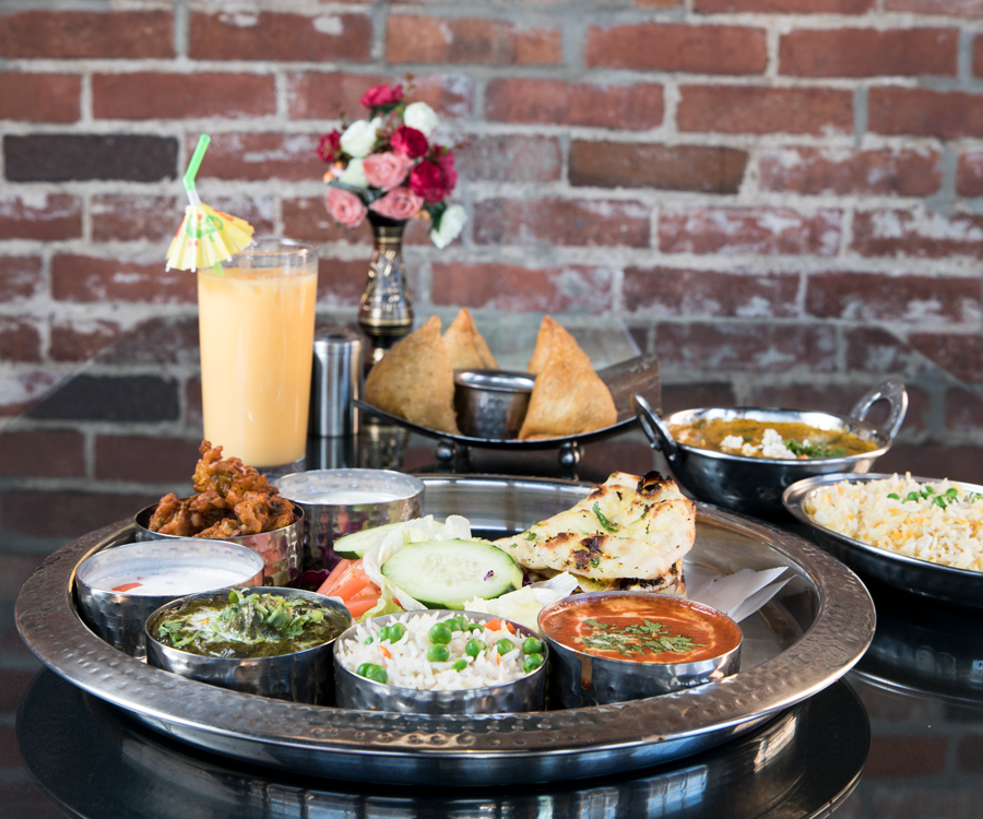 Indian food spread including curry, rice, naan and more