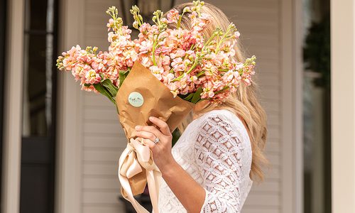 Jamie Stauffer holding a bouquet of flowers by Ozark Mtn Flower Truck in Springfield MO