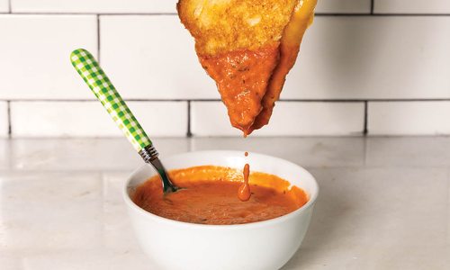 Toasted sandwich dipped in tomato soup