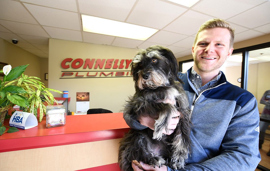 Lucy, a 4-year-old terrier mix and Brett Edwards at Connelly Plumbing, Heating & Air