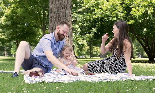 Family of three on a picnic in Phelps Grove Park in Springfield MO