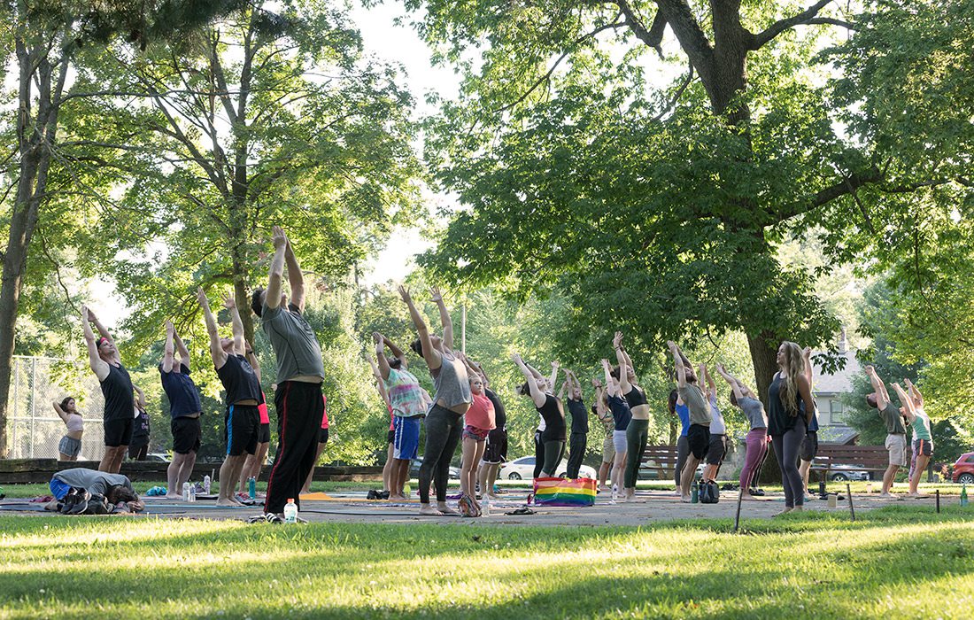 Large group of people doing yoga in Phelps Grove Park in Springfield MO