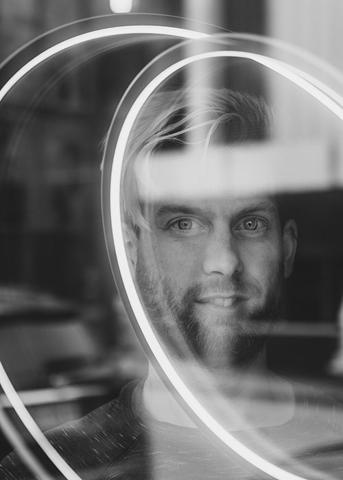 Jonathan Stratman through a window at the Mudhouse in downtown Springfield