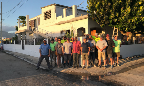 Juanito Borques with the group that renovated his home