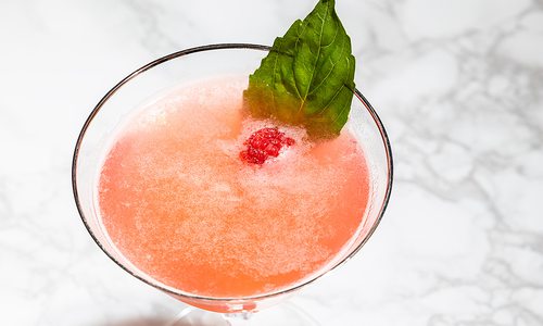 Raspberry Gin Smash on a marble tabletop.