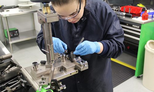 A technician assembles a high pressure common rail fuel injector
